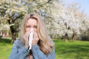 woman-outside-blowing-nose