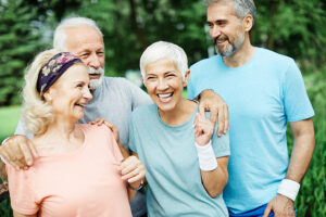 group of mature adults outside exercising