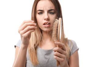 girl pulling hair out of hair brush